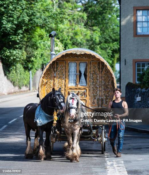 Man attends the Appleby Horse Fair, an annual gathering of travellers, in Cumbria.