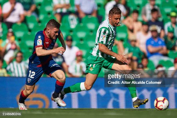 Joaquin Sanchez of Real Betis Balompie being followed by Javi Galan of SD Huesca during the La Liga match between Real Betis Balompie and SD Huesca...