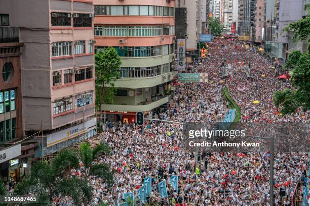 Protesters march on a street during a rally against a controversial extradition law proposal on June 9, 2019 in Hong Kong. Organizers say more than a...