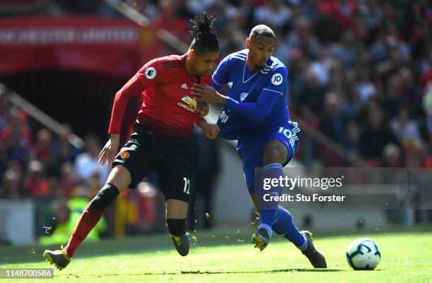 United player Chris Smalling challenges Kenneth Zohore of Cardiff during the Premier League match between Manchester United and Cardiff City at Old...