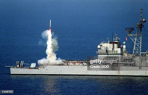 Tomahawk cruise missile launches from the stern vertical launch system of the USS Shiloh to attack selected air defense targets south of the 33rd...