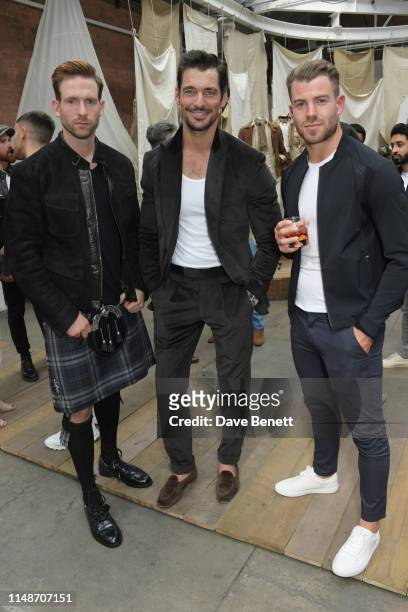 Craig McGinlay, David Gandy and Bradley Simmonds attend the Belstaff presentation during London Fashion Week Men's June 2019 at the Hoxton Docks on...