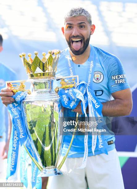 Sergio Aguero of Manchester City celebrates with the Premier League trophy during the Premier League match between Brighton & Hove Albion and...