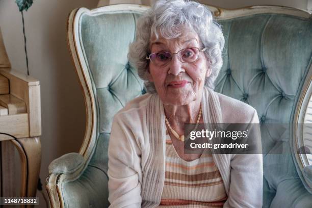 un sourire, confiant 100-year vieille femme dans sa maison - centenaire et plus photos et images de collection