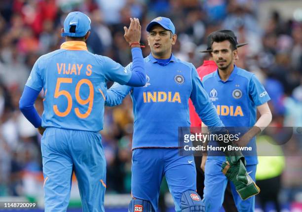 Dhoni celebrates with Vijay Shankar of India at the end of the Group Stage match of the ICC Cricket World Cup 2019 between India and Australia at The...