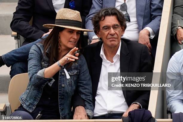 French philosopher Luc Ferry and his wife Marie-Caroline Becq Fouquieres attend the men's singles final match between Spain's Rafael Nadal and...