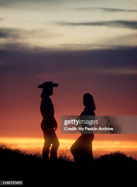 Silhouetted Diana Del Gorde and Gretchen Freed talk during an Oregon sunset circa September, 1958 in Oregon.