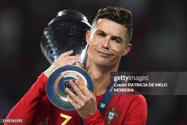 Portugal's forward Cristiano Ronaldo receives the trophy after winning the UEFA Nations League final football match between Portugal and The...