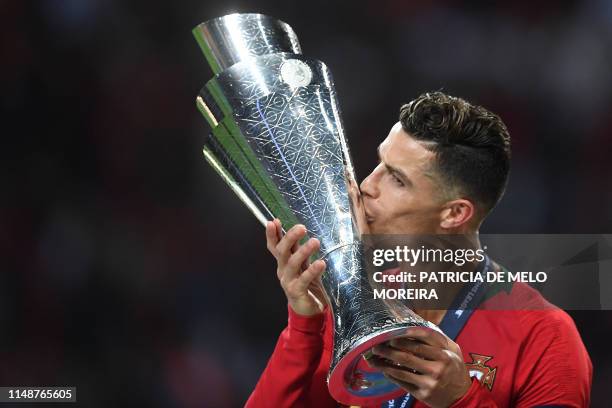 Portugal's forward Cristiano Ronaldo kisses the trophy after winning the UEFA Nations League final football match between Portugal and The...