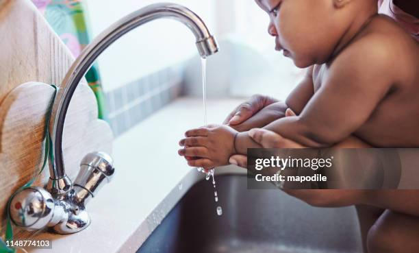 it's never too early to learn about hygiene - washing hands stock pictures, royalty-free photos & images