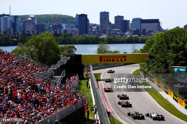 Sebastian Vettel of Germany driving the Scuderia Ferrari SF90 leads the field including Pierre Gasly of France and Red Bull Racing during the F1...