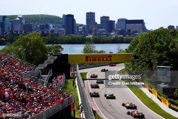 Sebastian Vettel of Germany driving the Scuderia Ferrari SF90 leads the field including Pierre Gasly of France and Red Bull Racing and Max Verstappen...