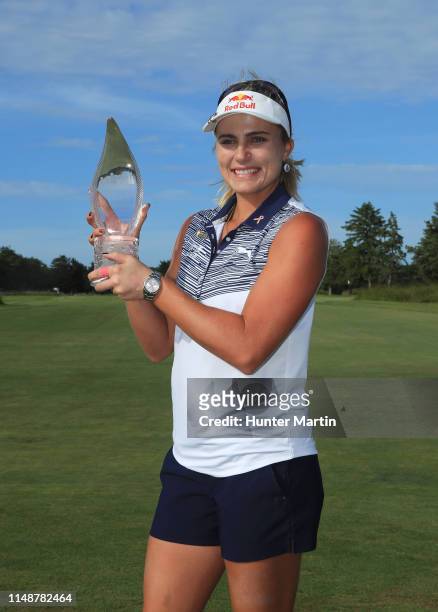 Lexi Thompson holds the championship trophy after winning the ShopRite LPGA Classic presented by Acer on the Bay Course at Seaview on June 9, 2019 in...