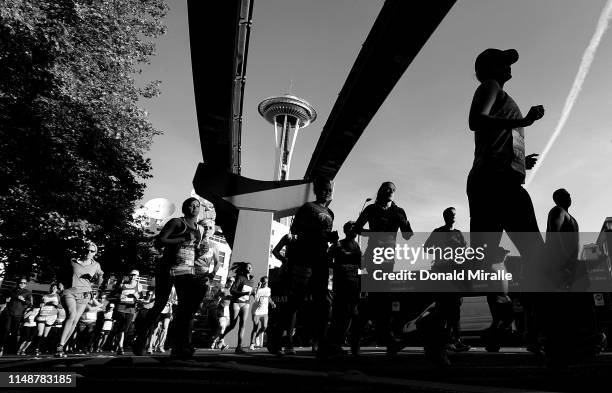 Competitors run with the monorail and Space Needle in the background during the 2019 Rock'n'Roll Seattle Marathon and 1/2 Marathon on June 9, 2019 in...