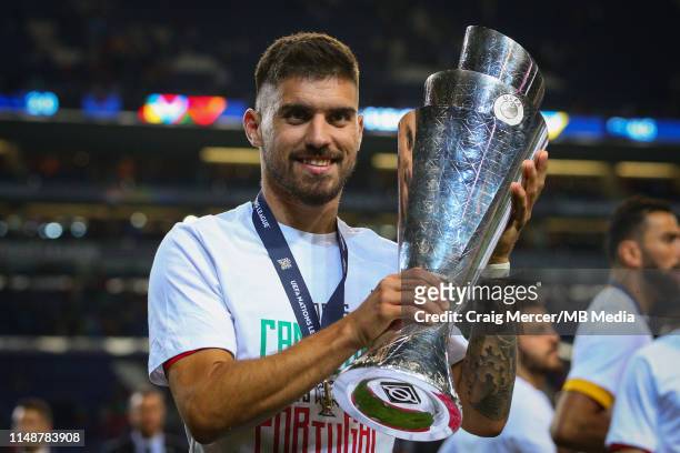 Ruben Neves of Portugal celebrates with the trophy after the UEFA Nations League Final between Portugal and the Netherlands at Estadio do Dragao on...