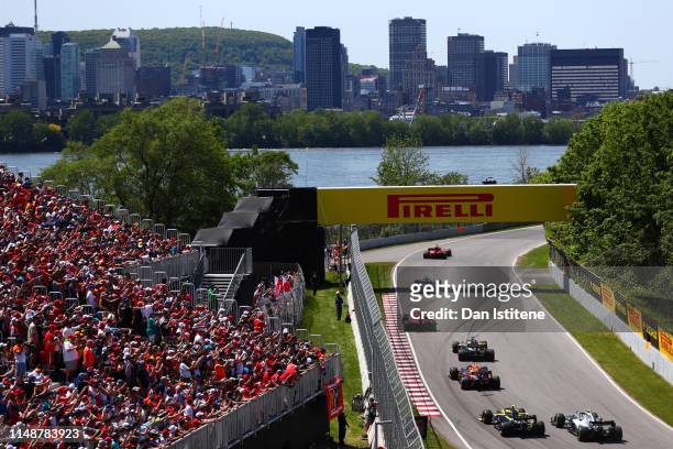 Sebastian Vettel of Germany driving the Scuderia Ferrari SF90 leads the field including Pierre Gasly of France and Red Bull Racing during the F1...