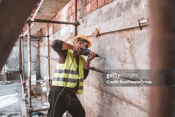 skilled maintenance worker at the workplace with his building tools - drill stock pictures, royalty-free photos & images