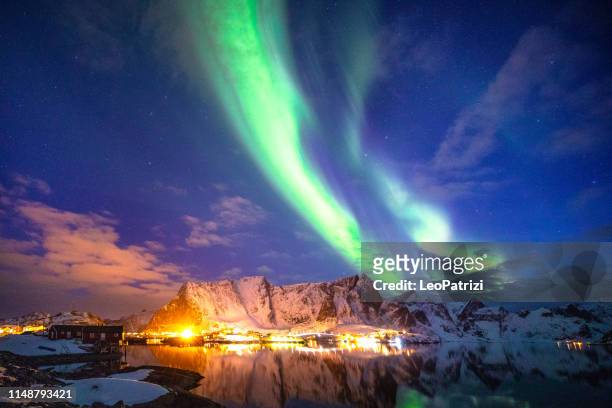northern lights in the sky of the lofoten islands in norway - - reine stock pictures, royalty-free photos & images