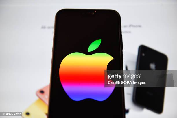 In this photo illustration an Apple logo with rainbow colors seen displayed on a smart phone.