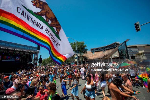 People participate in the annual LA Pride Parade in West Hollywood, California, on June 9, 2019. - LA Pride began on June 28 exactly one year after...