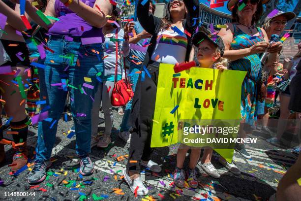 Young girl holds a sign during the annual LA Pride Parade in West Hollywood, California, on June 9, 2019. - LA Pride began on June 28 exactly one...