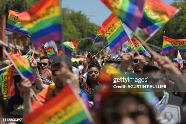 People participate in the annual LA Pride Parade in West Hollywood, California, on June 9, 2019. - LA Pride began on June 28 exactly one year after...