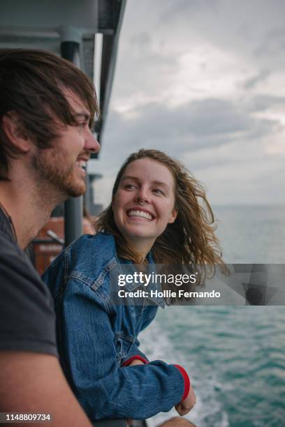 young couple on a ferry - ferry stock-fotos und bilder