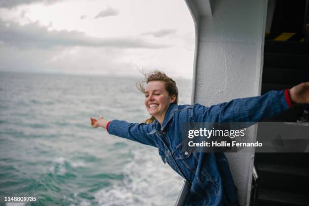 young woman enjoying life on ferry 2 - against their gags our freedom photos et images de collection