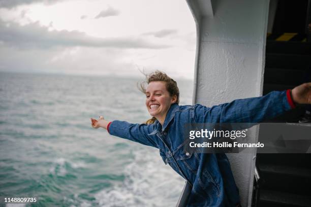 young woman enjoying life on ferry 2 - carefree stock pictures, royalty-free photos & images