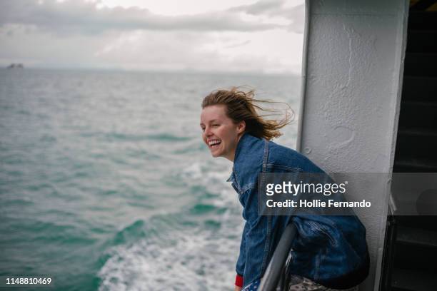 young woman enjoying life on ferry - fähre stock-fotos und bilder