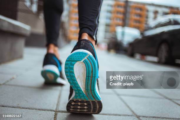 close up shot of runner's shoes - feet jogging imagens e fotografias de stock