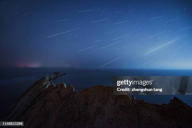 meteor shower. bo sea, liaoning, china. - meteor shower stock-fotos und bilder