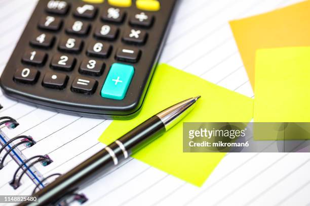 notebook with spirals and calculator and a note - broken calculator stock pictures, royalty-free photos & images