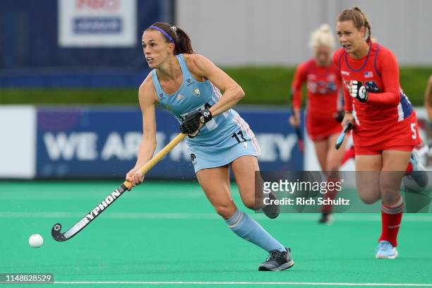 Carla Rebecchi of Argentina moves the ball as Casey Umstead of the United States chases during the Women's FIH Field Hockey Pro League match between...