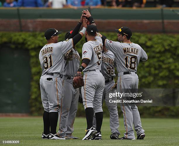 Jose Tabata, Andrew McCutchen, Ronny Cedeno, Xavier Paul and Neil Walker of the Pittsburgh Pirates celebrate a win over the Chicago Cubs at Wrigley...