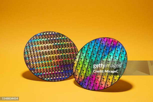 silicon computer wafer on yellow - computer wafer stock pictures, royalty-free photos & images