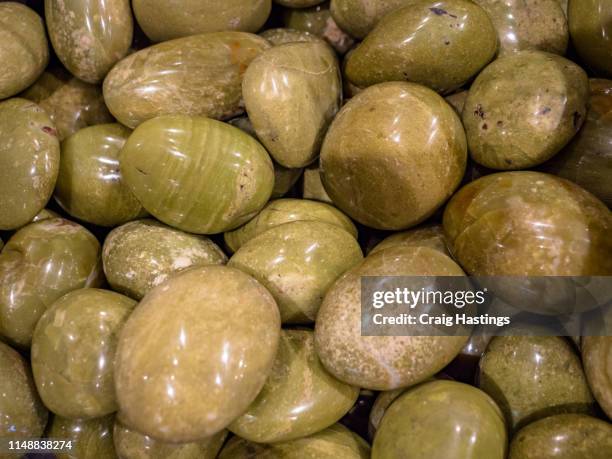 london, uk - april 15, 2019: collection of green opal semi precious stones and minerals. - jasper mineral stock pictures, royalty-free photos & images