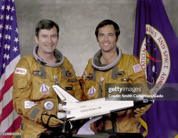 Crew members Commander John W Young and Pilot Robert L Crippen holding a space shuttle model, May 7, 1979. Image courtesy National Aeronautics and...