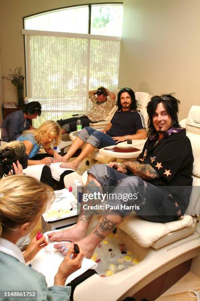 Nikki Sixx has foot treatment and his wife Ex Baywatch Actress Donna D'Errico treats another customer, the couple April 26, 2003 have opened a day...