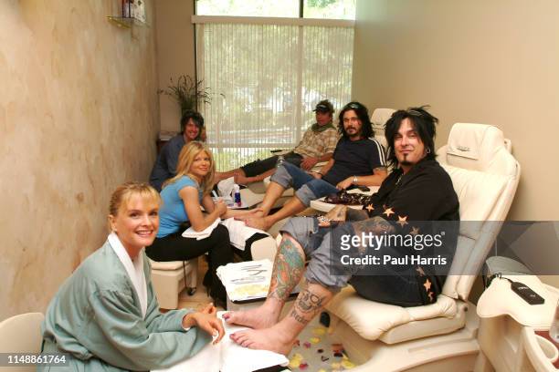 Nikki Sixx has foot treatment and his wife Ex Baywatch Actress Donna D'Errico treats another customer, the couple April 26, 2003 have opened a day...