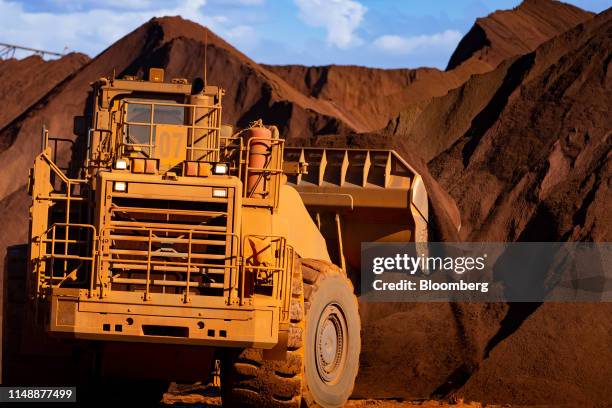 Excavators move iron ore at the port in Port Hedland, Australia, on Monday, March 18, 2019. Port Hedland is the nexus of Australias iron-ore...