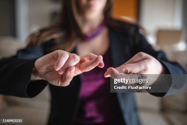 deaf woman showing sign language - american sign language stock pictures, royalty-free photos & images