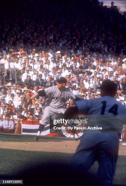 Pitcher Whitey Ford of the New York Yankees throws the pitch as first baseman Bill Skowron fields his position during Game 6 of the 1960 World Series...