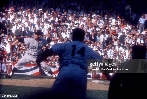 Pitcher Whitey Ford of the New York Yankees throws the pitch as first baseman Bill Skowron fields his position during Game 6 of the 1960 World Series...