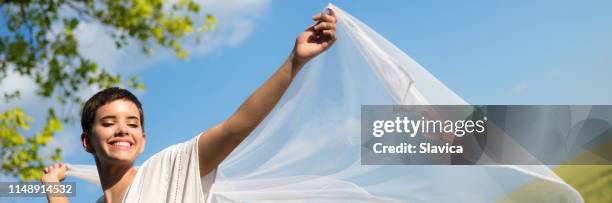 young happy woman dancing in the nature - woman in a shawl stock pictures, royalty-free photos & images