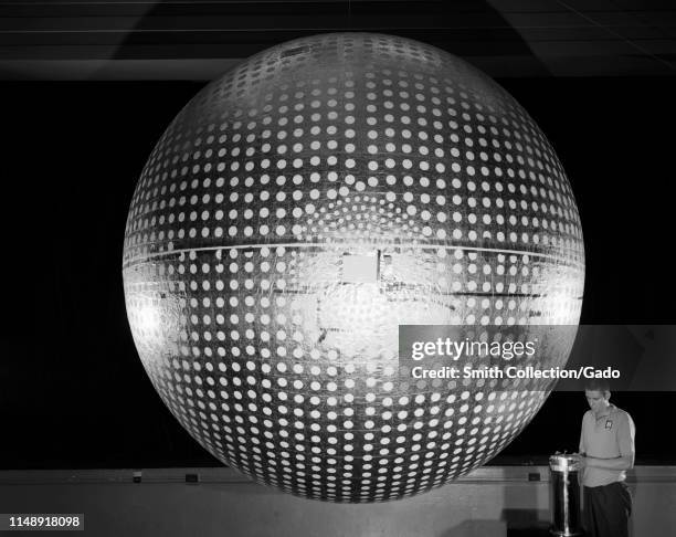 Engineer prepares Explorer 24 inflatable satellite at Langley Research Center, Hampton, Virginia, November, 1964. Image courtesy National Aeronautics...