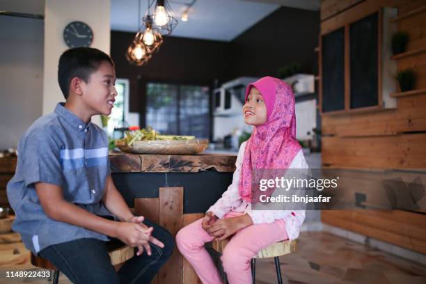 two kids talking to each other - family with two children stock pictures, royalty-free photos & images