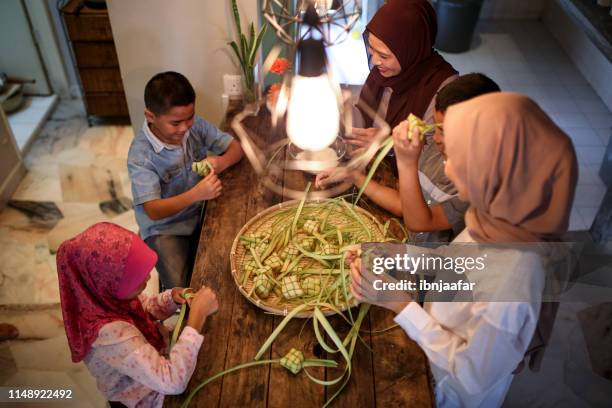 family gathering and preparing food - ketupat stock pictures, royalty-free photos & images