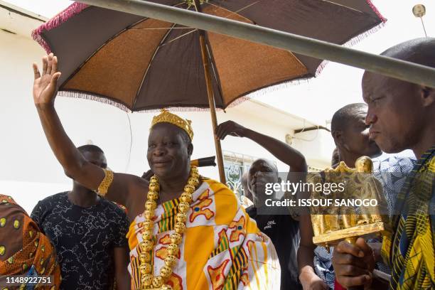 King Amon N'Douffou V , King of Krindjabo, capital of the Sanwi Kingdom, in the southeast of the Ivory Coast, waves as he arrives with other...