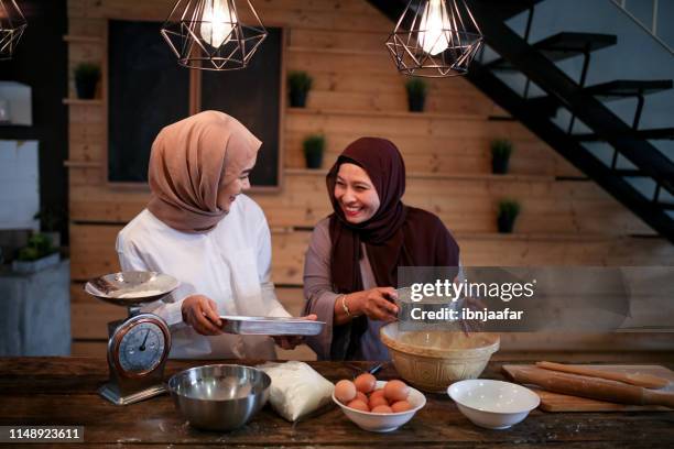 mother and daughter baking in kitchen - daughter cooking stock pictures, royalty-free photos & images